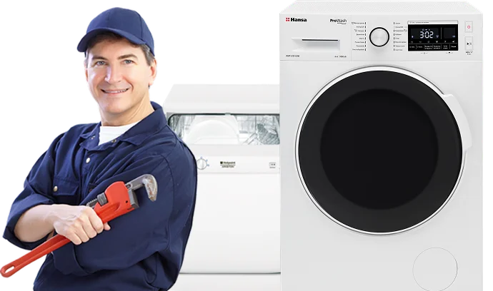 Hydraulik w ubraniu roboczym stoi przy pralce, trzymając klucz nasadowy i oferując profesjonalne usługi naprawy sprzętu i instalacji hydraulicznych.